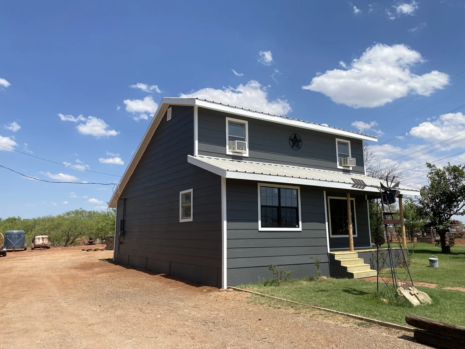 Completed gray exterior siding and white trim on a two-story home from Bruce’s project photos