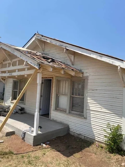 Weathered siding and exposed trim around the porch before the exterior makeover.
