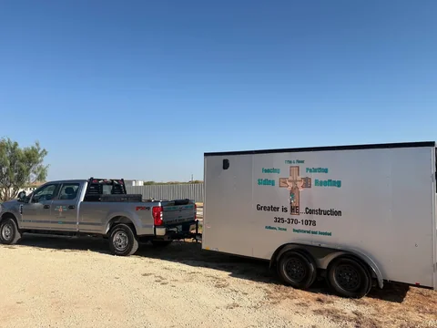 Greater Is He... Construction truck and branded enclosed work trailer.