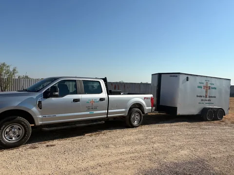 Another view of the Greater Is He... Construction pickup and work trailer.