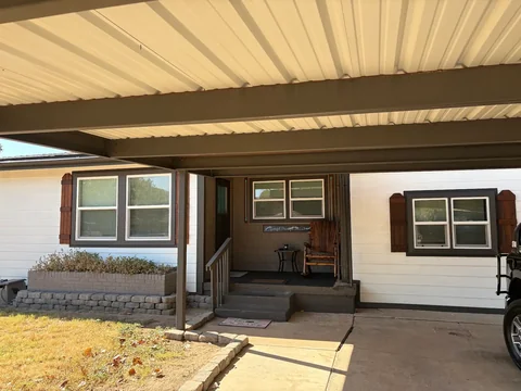Covered porch and finished front exterior at Bruce’s home.